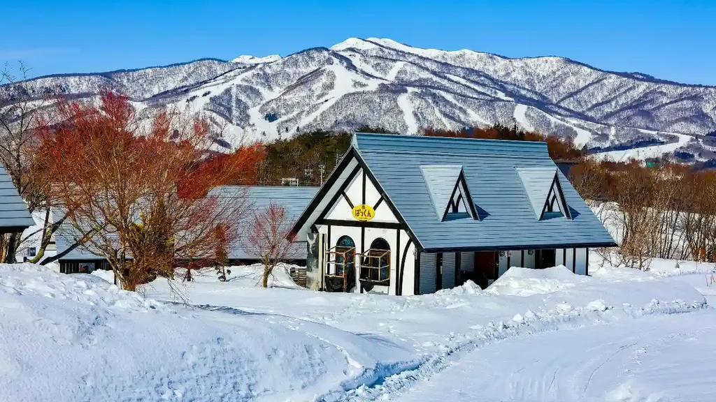 Cottage in Hokkaido, surrounded by snow-covered mountains