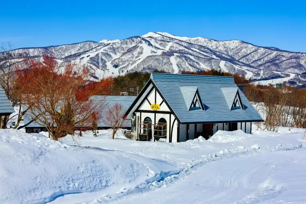 Cottage in Hokkaido, surrounded by snow-covered mountains