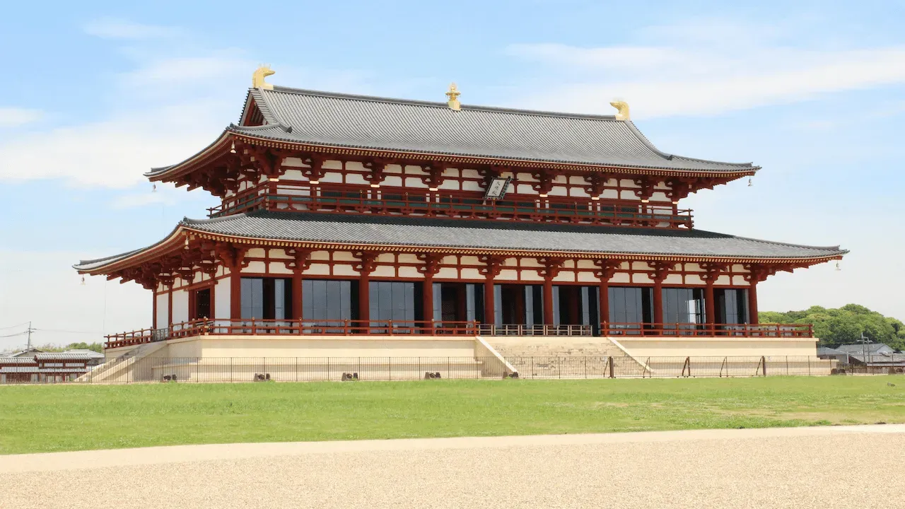 Japanese temple showcasing traditional architecture under a bright blue sky