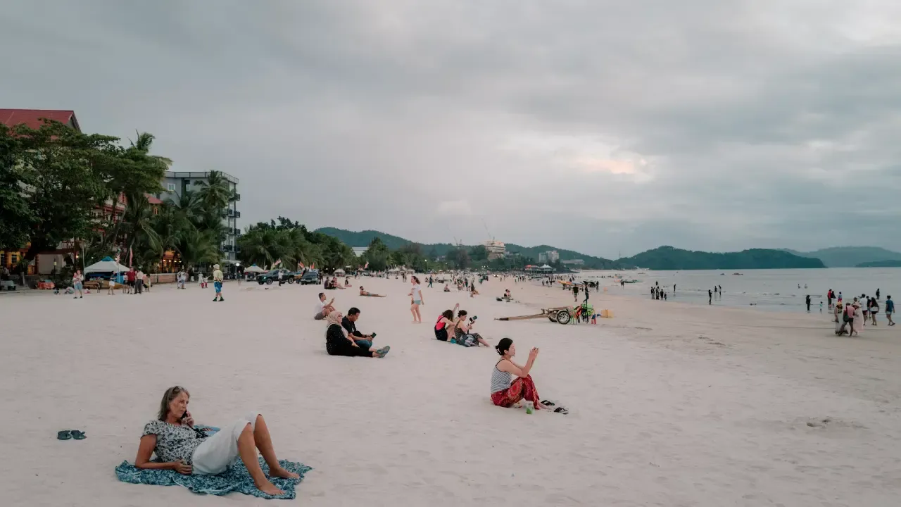 Tourists laying on the beach at langkawi while it is cloudy