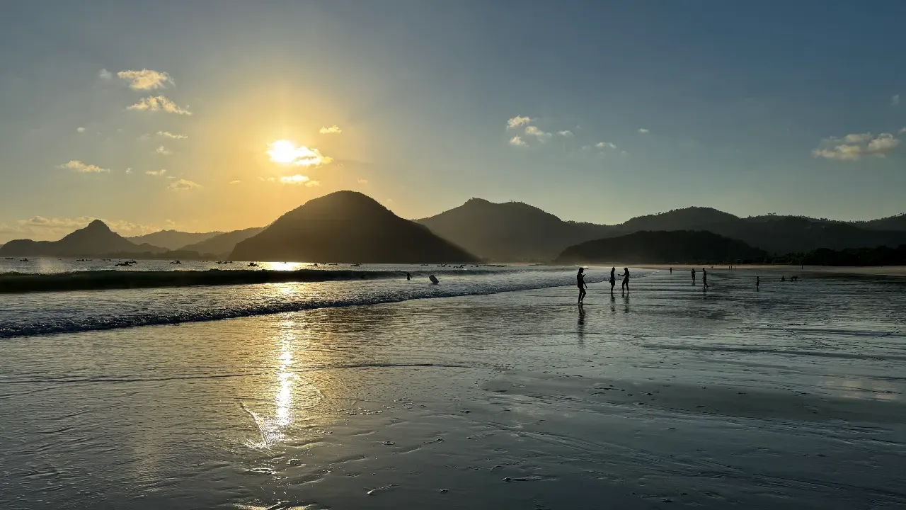 Selong Belanak beach at sunset with people walking