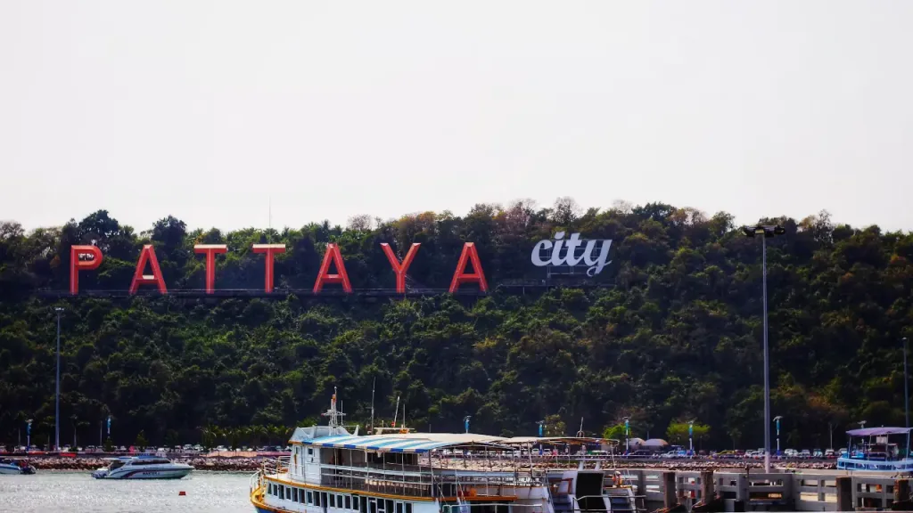 pattaya city sign with boats in foreground