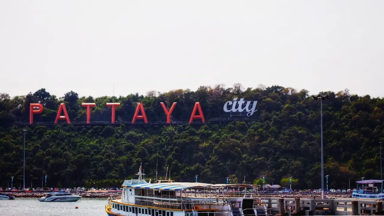 pattaya city sign with boats in foreground