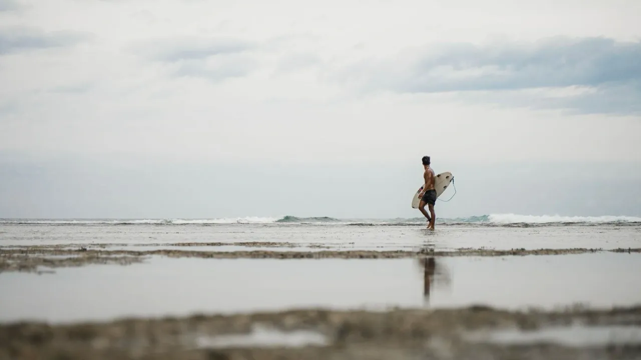 surfer looking out at the waves in siargao philippines